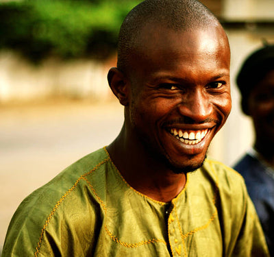 Man wearing a green shirt with a blurred background